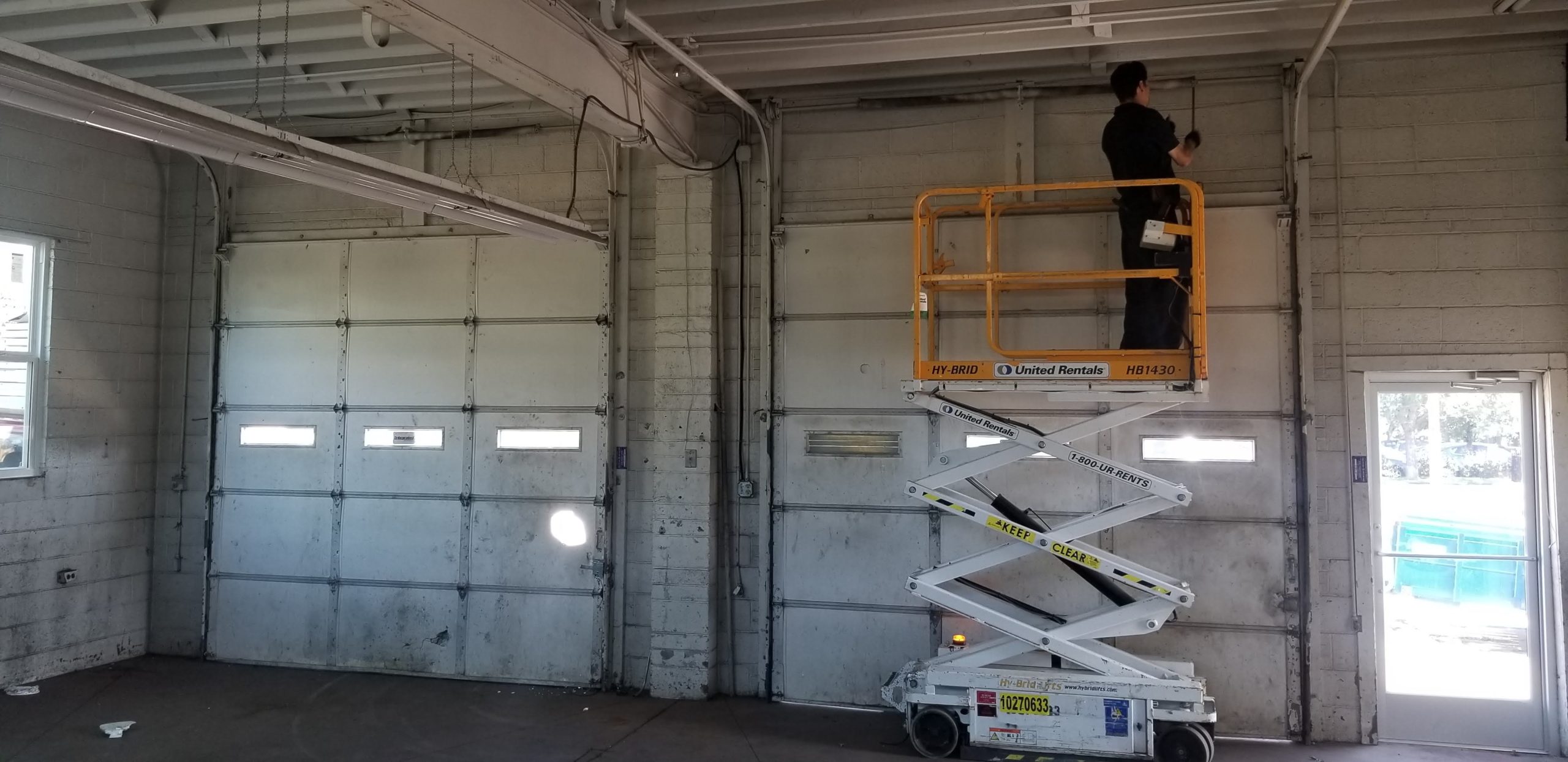 Using Scissor Lift for Garage Door Installation
